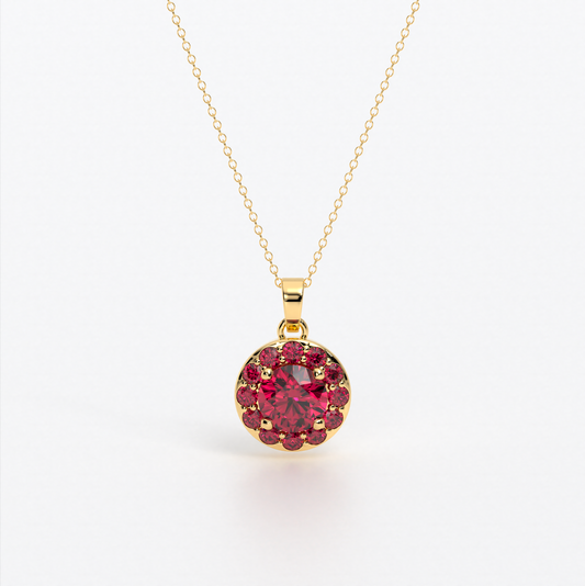 Colgante de oro de 18k con rubí central en talla brillante, rodeada por un halo de rubies, con un total de 2cts