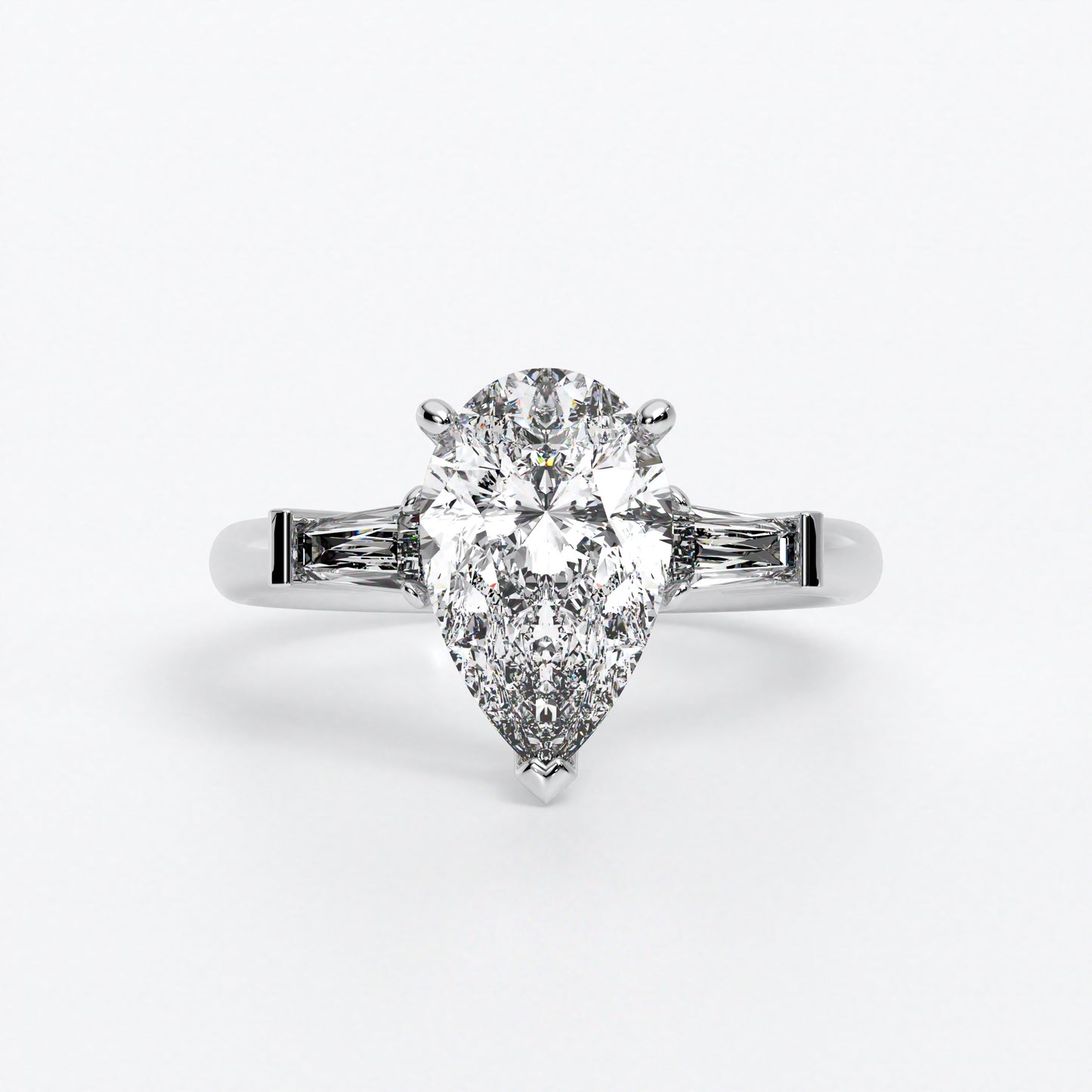 Anillo de oro blanco de 18K con diamante central en talla pera, 2 diamantes en talla trapecio