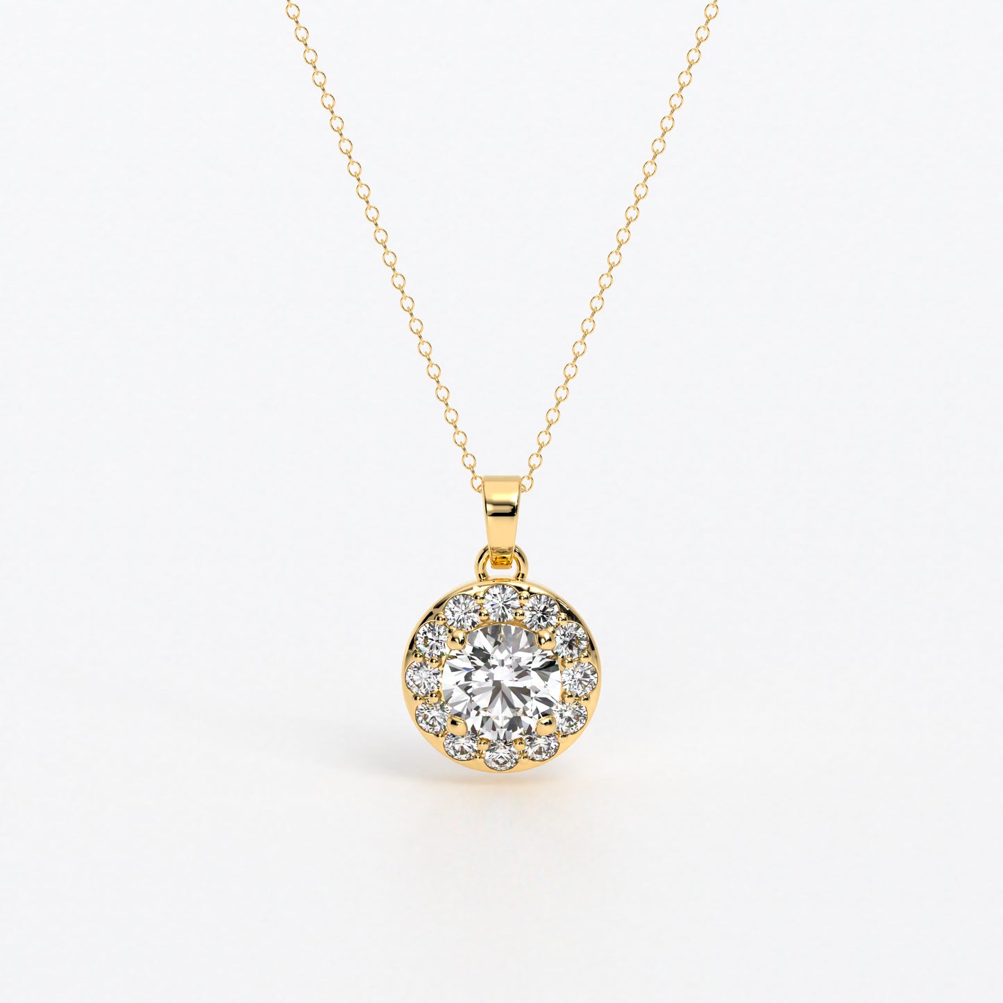 Colgante de oro de 18k con diamante blanco central en talla brillante de 0.95 cts, rodeada por un halo de diamantes blancos, con un total de 1,6cts