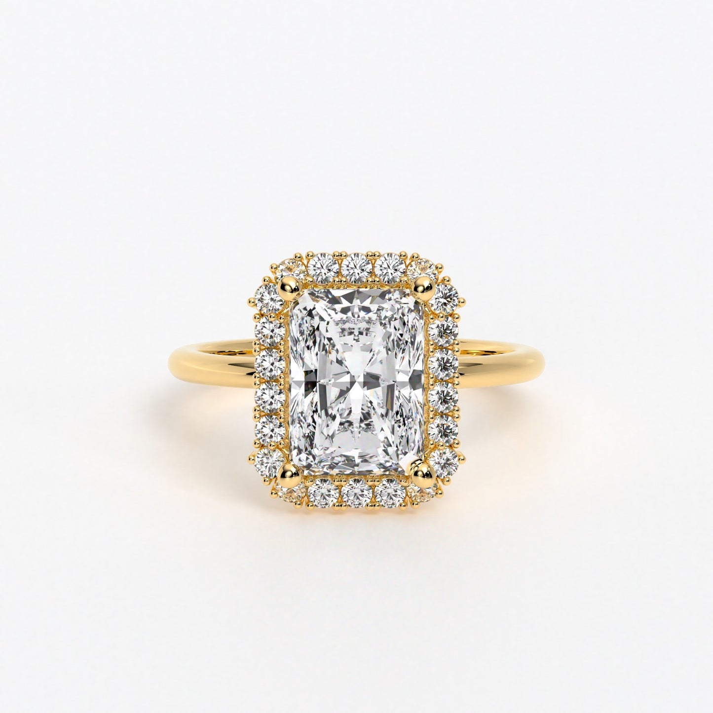 Anillo de oro de 18K con diamante blanco central talla radiant y diamantes blancos laterales