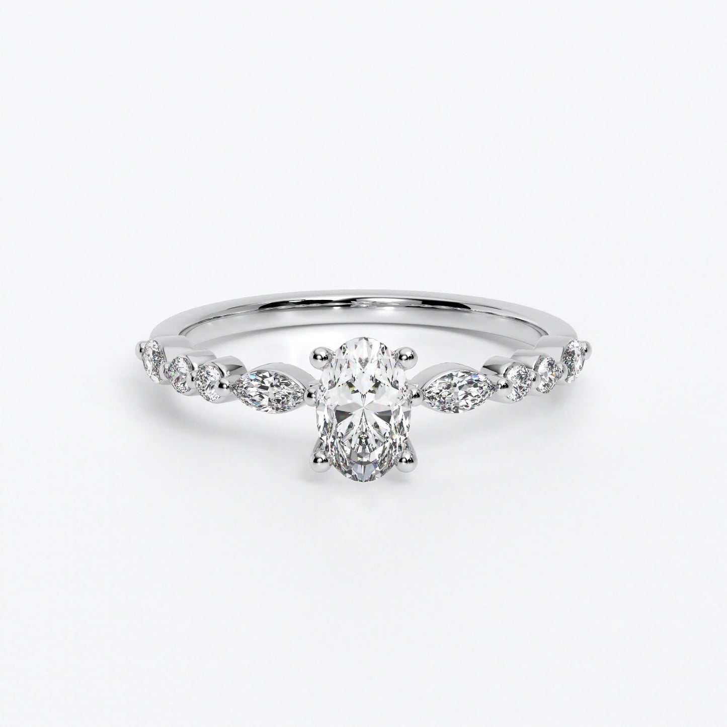 Anillo de oro de 18K con diamante oval central y diamantes laterales talla marquise