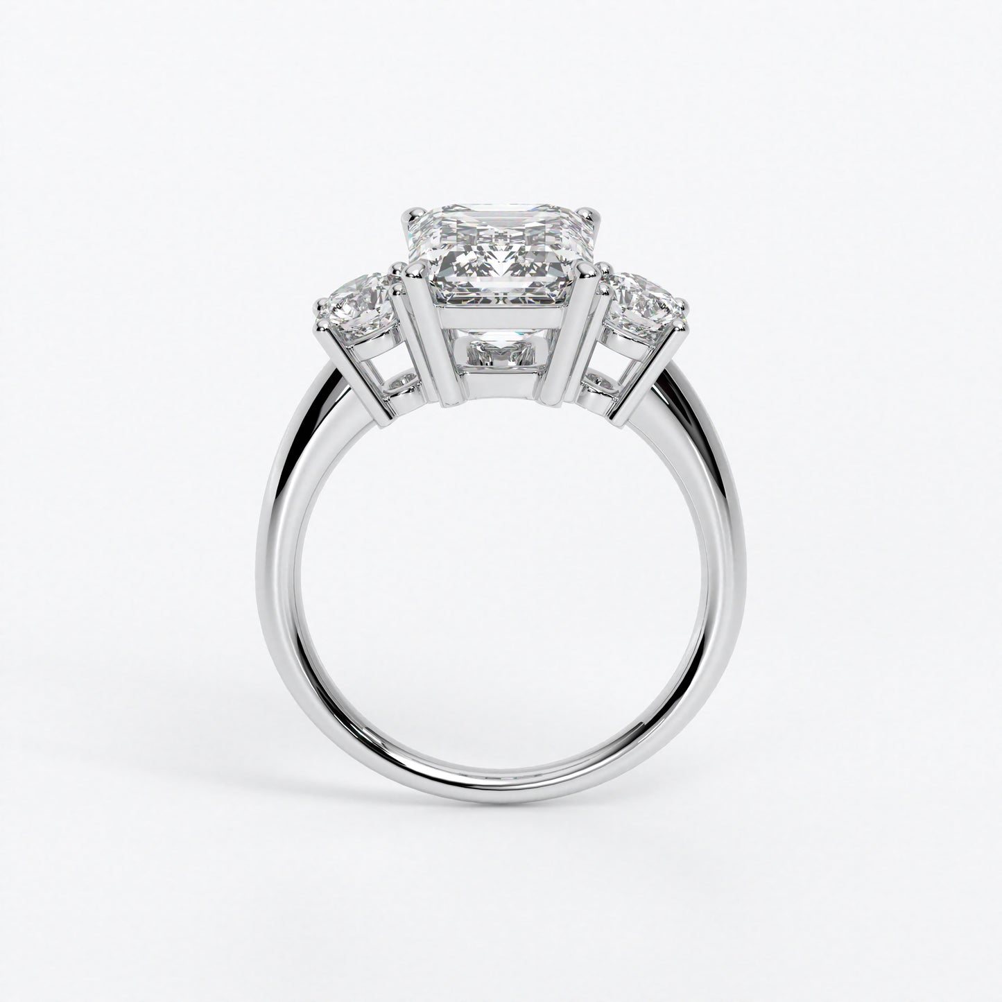 Anillo de oro blanco de 18K con diamante central en talla Esmeralda, 2 diamantes en talla brillante