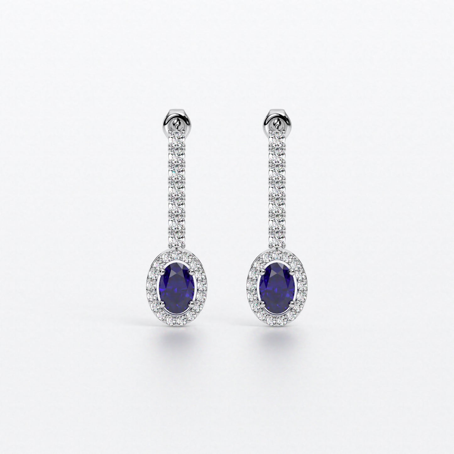Pendientes largos en oro blanco con zafiros ovales con halo de diamantes y línea superior de diamantes