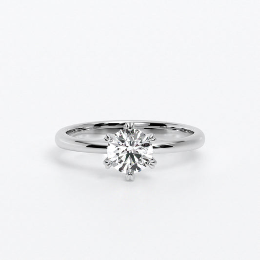 Solitario de oro blanco 18k con un diamante en talla brillante central de 0,4 con seis grapas