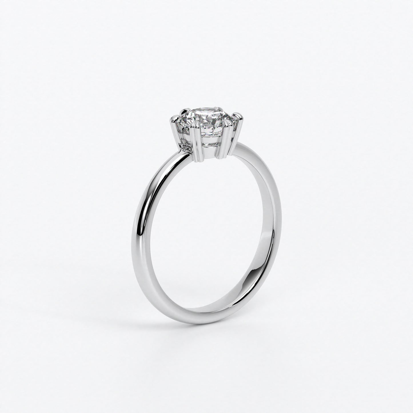 Solitario de oro blanco 18k con un diamante en talla brillante central de 0,4 con seis grapas