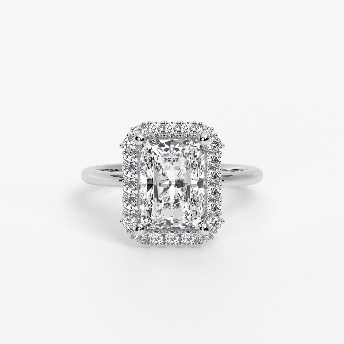 Anillo de oro de 18K con diamante blanco central talla radiant y diamantes blancos laterales