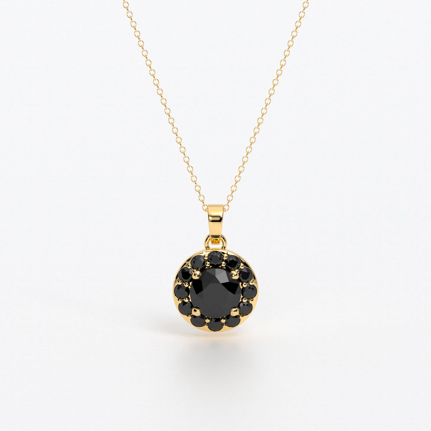 Colgante de oro de 18k con diamante negro central en talla brillante, rodeada por un halo de diamantes negros, con un total de 1,1cts